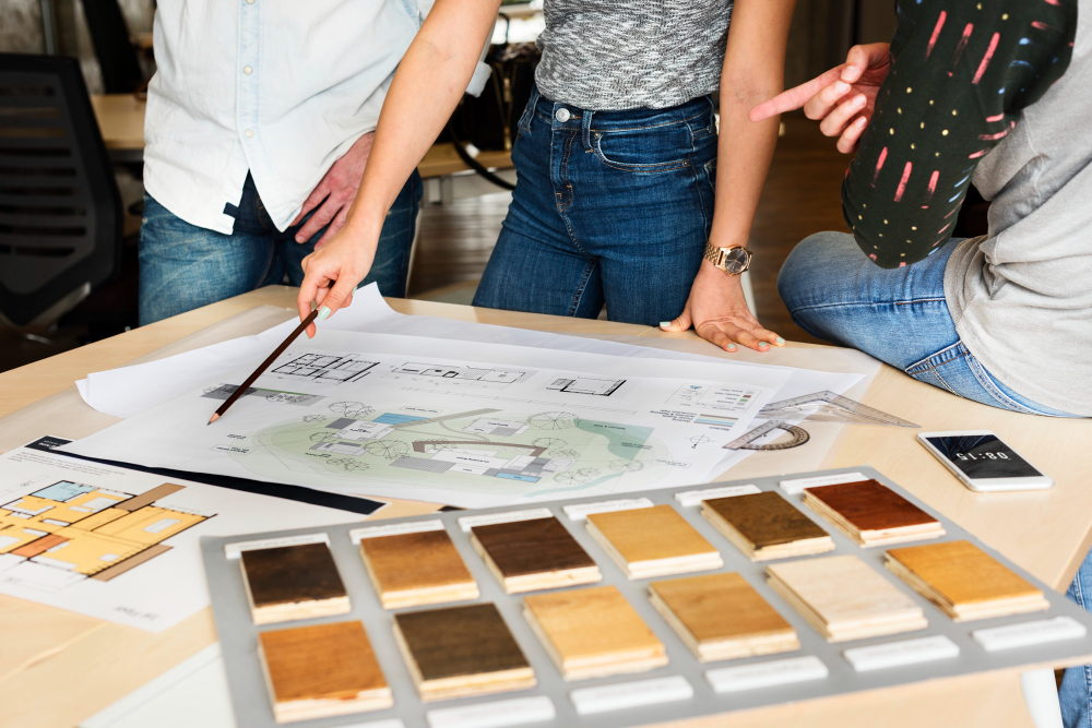 A person reviewing home renovation plans and material samples.